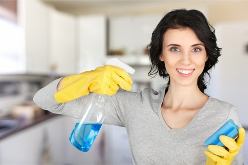 Cleaner removing grease from an oven in a SE11 flat kitchen