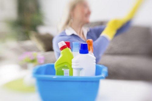 Local oven cleaner working in a South London kitchen with limited access
