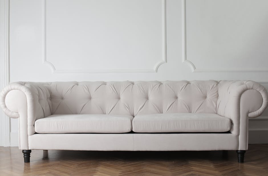 A long, modern seating bench upholstered in bright blue fabric, situated against a plain white wall in an indoor setting, with smooth, clean surface and visible cushion seams. The floor beneath is light-colored and appears well-maintained, reflecting a tidy appearance. No additional objects or tools are visible, indicating a neat and hygienic environment. This image exemplifies surface cleaning and maintenance, aligning with professional domestic or commercial cleaning standards provided by Carpet Cleaning SE11, situated in a well-lit, orderly space suitable for hygienic and deep cleaning services in the Kennington area, SE11.